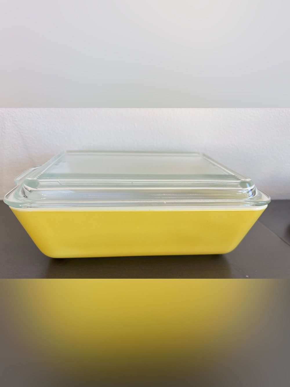 Vintage Pyrex 503 yellow refrigerator dish with a clear, ribbed lid.